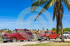 American red brown vintage cars parked under blue sky near the beach in Havana Cuba - Serie Cuba