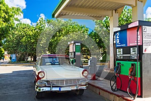 American red white classic car on the gas station in Varadero Cuba - Serie Cuba Reportage