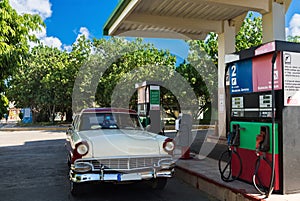 American red white classic car on the gas station in Varadero Cuba - Serie Cuba Reportage photo
