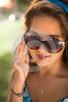 American redhead girl in suglasses. Photo in 60s style.