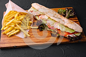 American sandwich baguett with ham steak and french fries