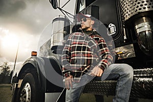 American Semi Truck Driver in Front of His Heavy Duty Vehicle