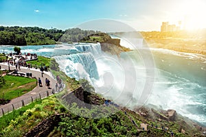 American side of Niagara falls, NY, USA. Tourists enjoying beautiful view to Niagara Falls during hot sunny summer day photo