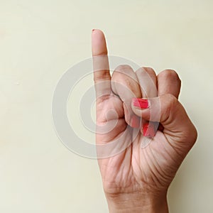 american sign language alphabet letter i displayed with isolated hand on light background