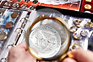 American silver dollar with magnifying glass