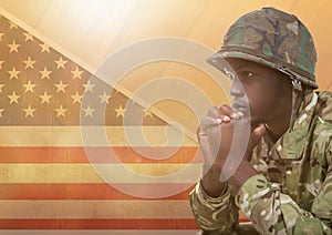 American Soldier thinking against american flag