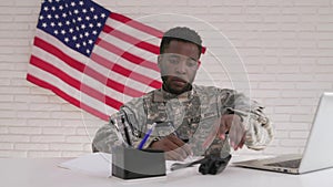 American soldier working with laptop in headquarter building