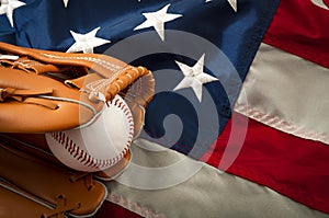 American sports and college athletics concept with the USA flag in the background and macro on a vintage baseball glove holding a