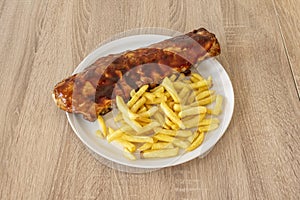 American-style marinated pork ribs garnished with French fries