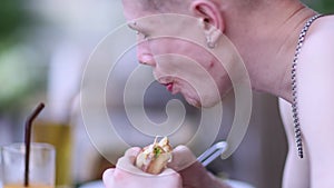 American style. Young man eating burger. People eat unhealthy meal. Getting satisfaction from unhealthy food.