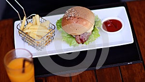 American style. Young man eating burger. People eat unhealthy meal. Getting satisfaction from unhealthy food.