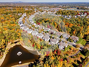 American suburb, view from above. Autumn landscape with colorful trees. Real estate, residential buildings of one-story America