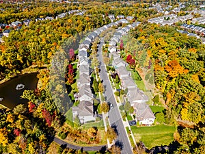 American suburb, view from above. Autumn landscape with colorful trees. Real estate, residential buildings of one-story America