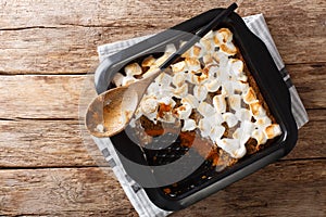 American sweet potato casserole with marshmallows close-up in a baking dish. Horizontal top view