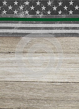 American thin green line flag over weathered wood background
