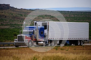 Arizona, USA - May, 2020: American truck. American style truck on freeway pulling load. Transportation theme. Road cars