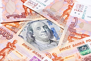 American us dollars lying among russian rubles, saving money from devaluation concept