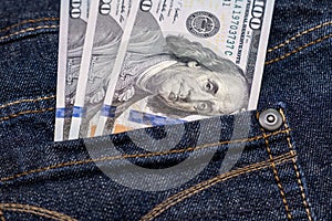 American us one hundred dollar banknotes in a jeans pocket