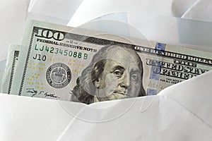 American US one hundred dollar bill in white envelope