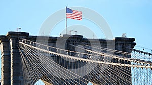 American or usa flag wawing top of Brooklyn bridge new york city