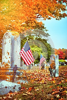 American veteran flags in autumn cemetery