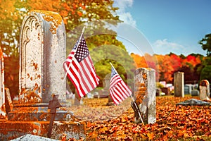 American veteran flags in autumn cemetery