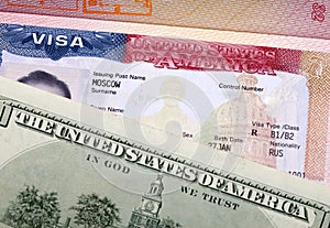 American visa on page of the international passport and US dollars