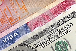 American visa on page of the international passport and US dollars, closeup