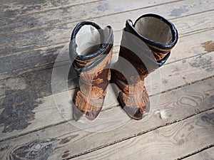 American West rodeo cowboy pair of traditional leather roper style western riding boots with authentic ranching spurs with hat and