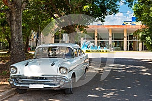 American white 1957 vintage car parked in the shadow under a tree in Havana City Cuba - Serie