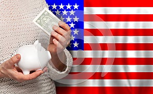 American woman with money bank on the background of USA flag. Dotations, pension fund, poverty, wealth, retirement concept