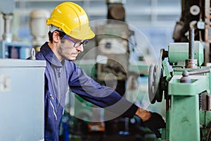 American worker young man.engineer smiling for service maintenance fix machine in heavy industy with safty suit and helmet