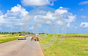 American yellow 1957 vintage car on the country road near Cienfuegos in Cuba - Serie Cuba Reportage