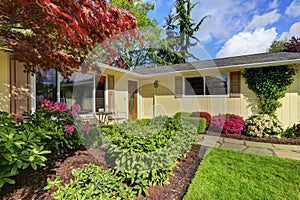 American yellow rambler style house exterior