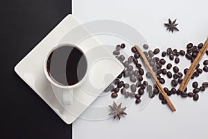 Americano with cinnamon and coffee bean on black and white background