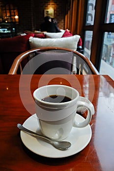 Americano coffee in a cup on wooden table