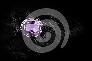 Amethyst gemstone on black coal background