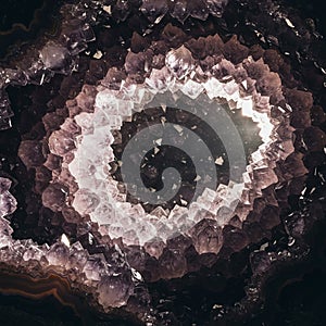 Amethyst geode interior featuring layers of purple quartz crystals (SiO?). The crystals