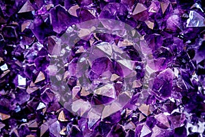 Amethyst purple crystal. Mineral crystals in the natural environment. Texture of precious and semiprecious gemstone.