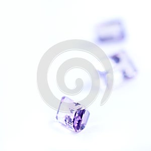 Amethyst, rocks or stone in studio by white background for natural resource, jewelry and baguette for luxury. Gemstone