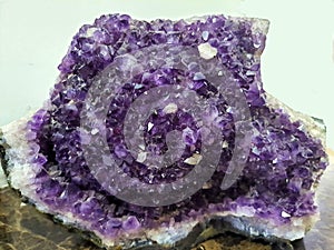 Purple amethyst stone isolated .Glossy violet texture of natural amethyst.