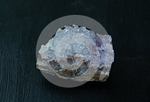 Amethyst violet variety of quartz from Brazil. Natural mineral stone on black background. Mineralogy, geology, magic of
