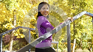 Amiable female model posing on sports ground in autumn