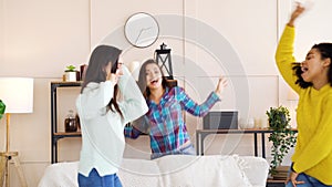 Amiable girls having fun and dancing in living room