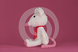 A soft DIY toy made of natural cotton and wool. Cute little rat crocheted, handmade art. Amigurumi one white mouse with