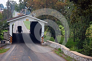 Amish buggy through a covered bridge