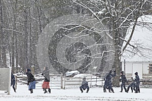 Amish Children having a snowball fight