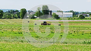 Amish Farmer Harvesting His Crop with 4 Horses and Modern Equipment