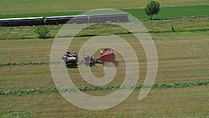 Amish Farmer Harvesting His Crop with 4 Horses and Modern Equipment
