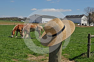 Amish hat on a farm fence post